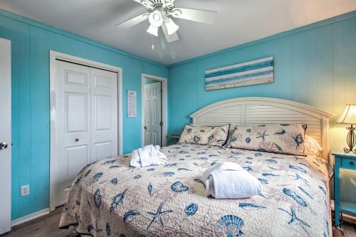 a bedroom with a bed with blue walls and a ceiling at Hilton Head Resort Condo with Beach and Pool Access! in Hilton Head Island