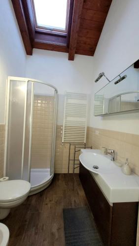 a bathroom with a toilet and a sink and a shower at BAITA LOVELY AND CENTRAL SAUZE D'OULX in Sauze dʼOulx