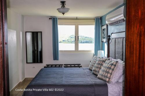 a bedroom with a bed and a window at Costa Bonita Private Villa 602 in Culebra