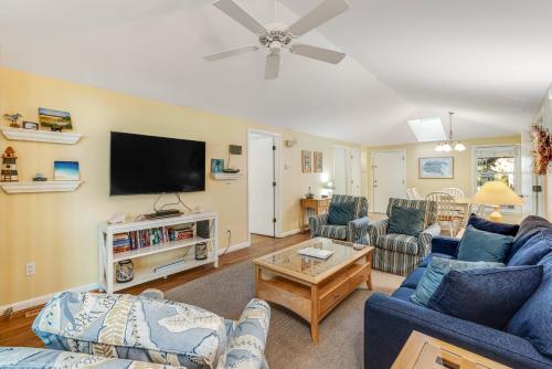 a living room with couches and a flat screen tv at Summerwind Cottage 1157 in Seabrook Island
