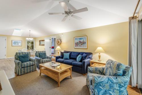 a living room with blue furniture and a ceiling fan at Summerwind Cottage 1157 in Seabrook Island