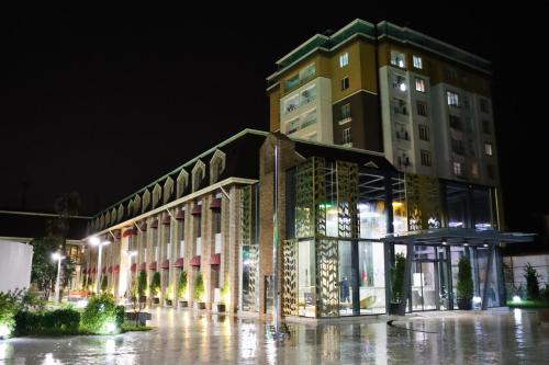 a large building at night with a building at Mandarinnart HOTEL in Astara