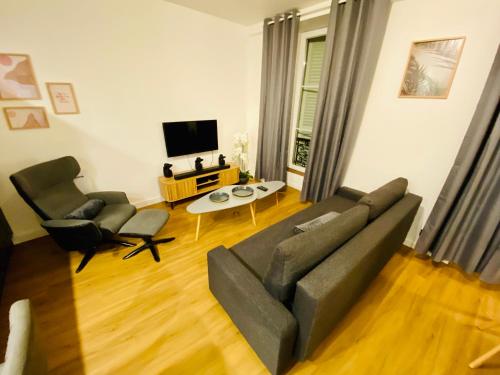 a living room with a couch and two chairs at Le doux refuge - 50m2 flat in the heart of Orleans in Orléans
