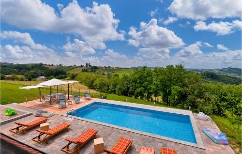 a swimming pool with chairs and a patio with at Nice Home In Zelezna Gora With Sauna in Grabrovnik
