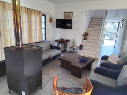 a living room with a couch and a fireplace at Kampi Double Storey House in the Village in Nicosia