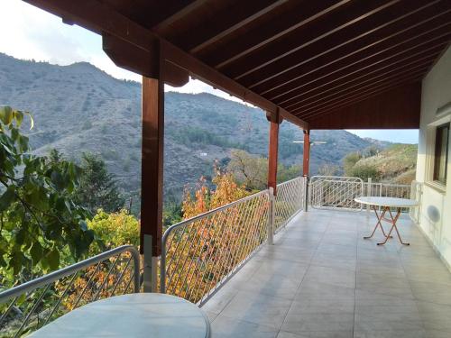 a balcony with a table and a view of a mountain at Kampi Double Storey House in the Village in Nicosia
