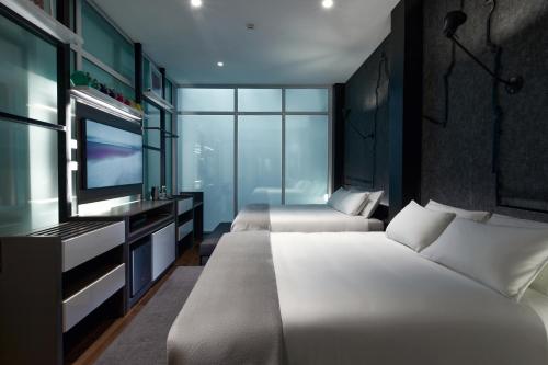 Ein Bett oder Betten in einem Zimmer der Unterkunft Casa Firenza Hotel & Suites Boutique