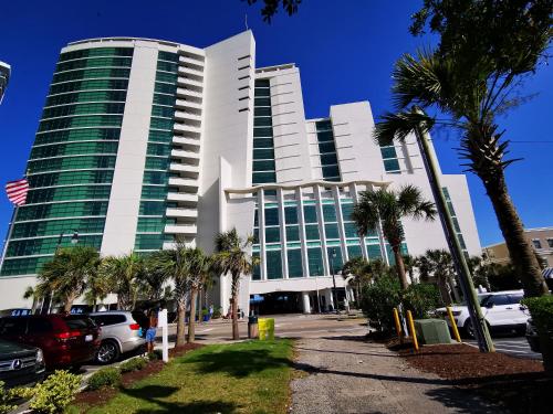 a tall building with palm trees in front of it at Gorgeous Condo 3 Br 3 Balconies SB 11th Floor in Myrtle Beach