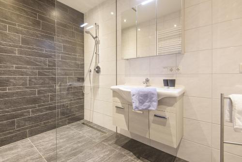 a bathroom with a sink and a shower at Apartment Gschwandtner Haus Stoareich in Bad Gastein