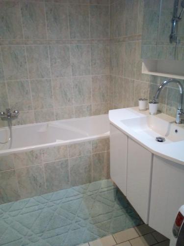 une salle de bain avec une baignoire et un lavabo dans l'établissement L'EUROPEEN Centre-inst européennes, à Strasbourg