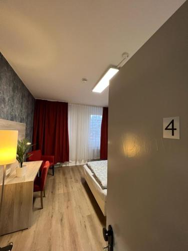 a room with a bed and a table in it at Black Sheep in Cologne