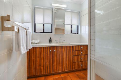 a bathroom with a sink and a mirror and a shower at Scotshaven in Port Fairy