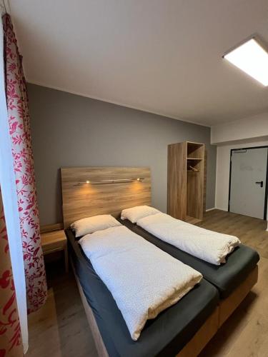 a bedroom with two beds with white towels on them at Black Sheep in Cologne