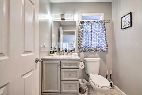 a small bathroom with a toilet and a sink at Cozy Tobyhanna Cottage with Private Hot Tub! in Tobyhanna