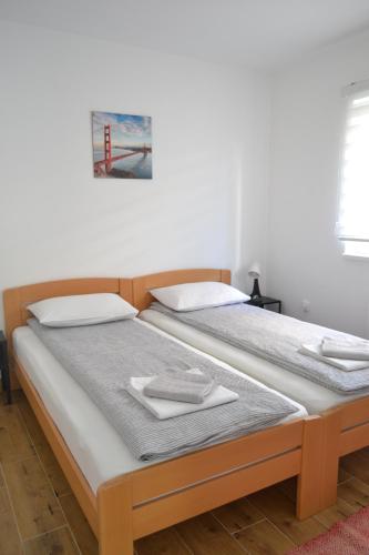 two beds sitting next to each other in a room at MK Zlatibor in Zlatibor