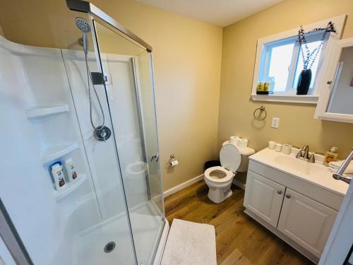 a bathroom with a shower and a toilet and a sink at Far East Escape- Salem in Salem
