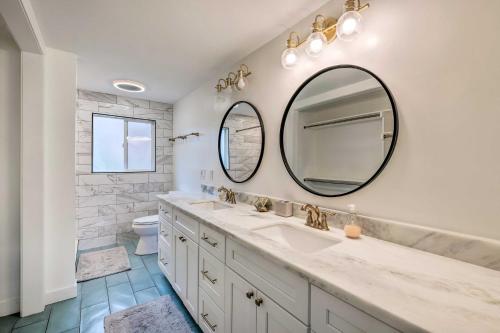 a bathroom with a sink and a mirror at Spacious Layton Retreat with Private Hot Tub! in Layton
