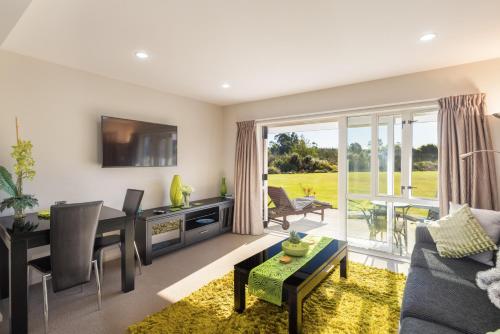 a living room with a couch and a table at The Meadows Villa in Christchurch