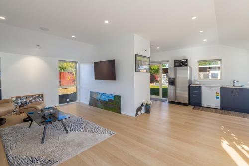 a living room with a couch and a table at The Meadows Villa in Christchurch