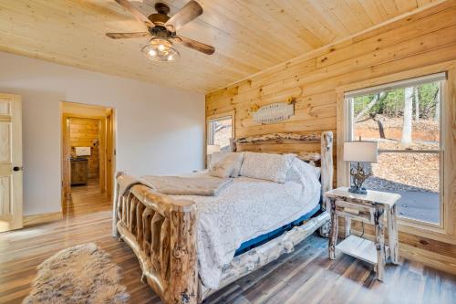 a bedroom with a bed and a ceiling fan at Cabina di Christina in Dahlonega