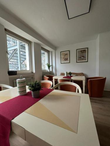 a dining room with tables and chairs and a table with a purple cloth at Black Sheep in Cologne