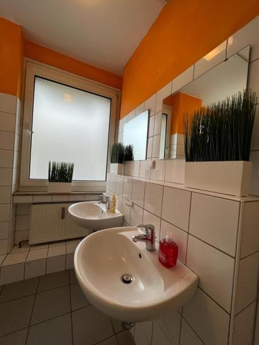 a bathroom with two sinks and two windows at Black Sheep in Cologne