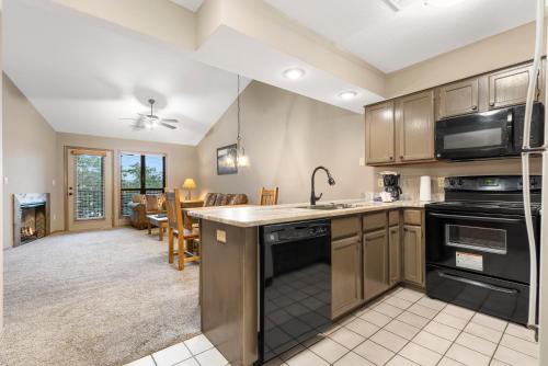 a kitchen with a sink and a stove top oven at Table Rock Resorts at Indian Point in Branson