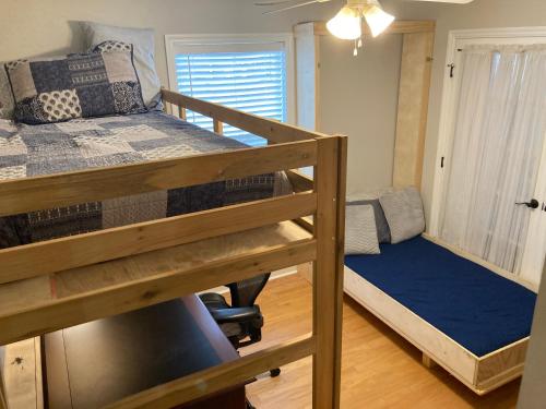 a dorm room with two bunk beds and a window at Spacious 3 Bedroom 2 bath Condo close to Five-points in Athens in Athens