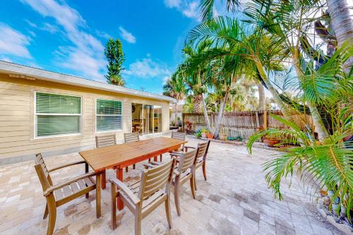 a wooden table and chairs on a patio at Paradise Found in Clearwater Beach