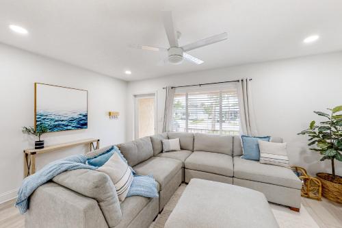 a living room with a couch and a ceiling fan at Paradise Found in Clearwater Beach