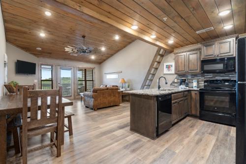an open kitchen and living room in a log home at Table Rock Resorts at Indian Point in Branson