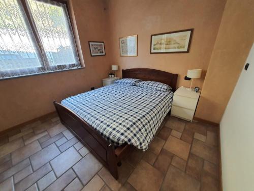a bedroom with a bed and two night stands and a window at Residenza La Cascata in Calolziocorte