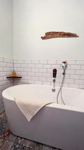 a white bath tub in a white bathroom with a shelf at Alto el Monte 2 - AR1414 in Bocines