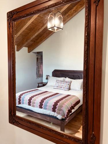 a mirror reflecting a bed in a room at Alto el Monte 2 - AR1414 in Bocines