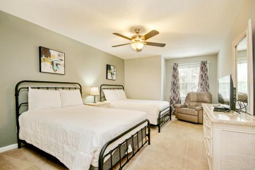 a bedroom with two beds and a ceiling fan at Fairway Oaks Getaway in Myrtle Beach