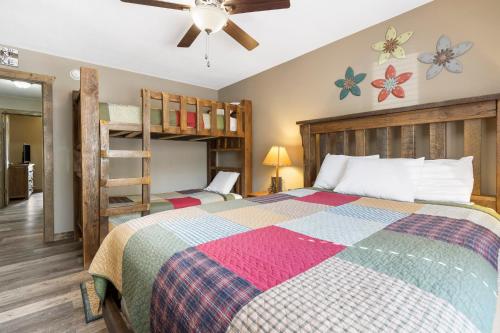 a bedroom with a bed and a bunk bed at Table Rock Resorts at Indian Point in Branson