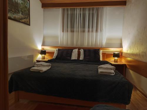 een slaapkamer met een bed met twee handdoeken erop bij Apartman 602 in Kopaonik