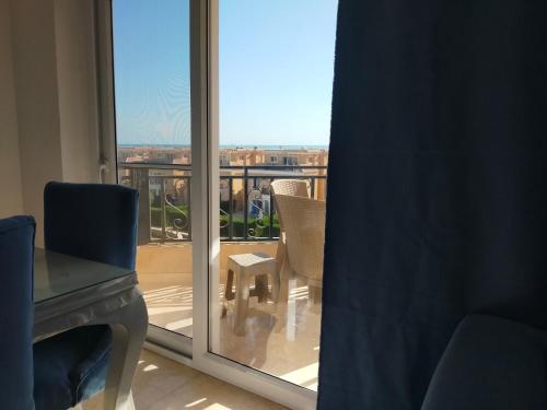 a room with a window with a view of a balcony at Red Sea Panorama in Hurghada