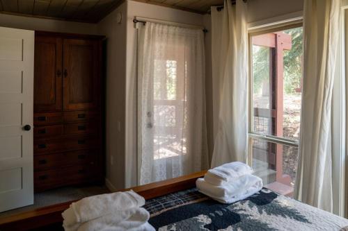 a bedroom with a bed with two towels on it at Golf Club Condos #437 in Truckee
