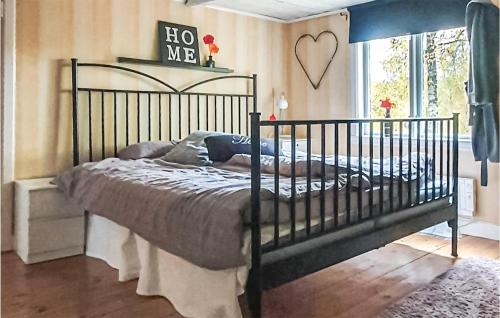 a bedroom with a black bed and a heart sign on the wall at 2 Bedroom Stunning Home In Aneby in Aneby