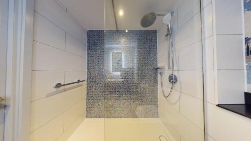 a shower with a glass door in a bathroom at Holiday Inn Brentwood by IHG in Brentwood