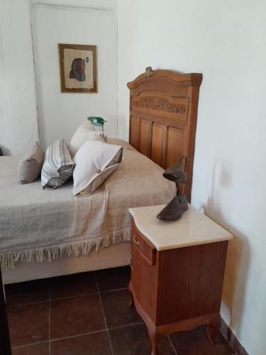 a bedroom with a bed and a table with a lamp at Mykonos Carmelo in Carmelo