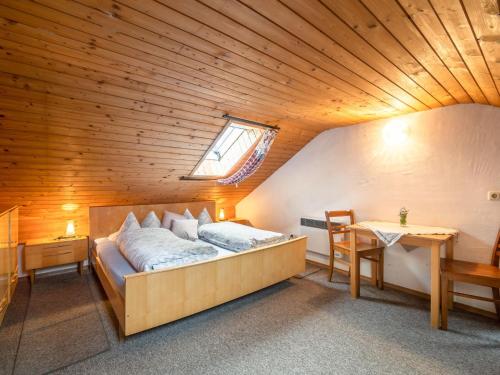 a bed in a room with a wooden ceiling at Delightful Holiday Home in Unterammergau with Terrace in Unterammergau