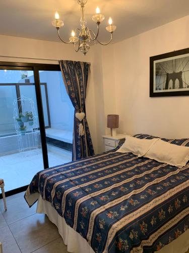 a bedroom with a bed and a window at Hermoso departamento boutique con pileta in Salta