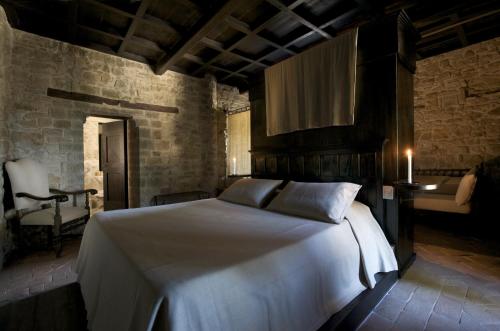 a bedroom with a large white bed in a room at Castello Di Monterone in Perugia