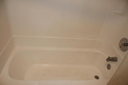 a white bath tub with a faucet in a bathroom at Travelodge by Wyndham Blythe in Blythe