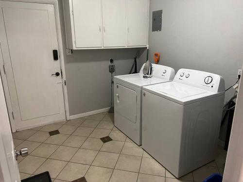 a small laundry room with a washer and dryer at Modern Home Near Downtown in Denver