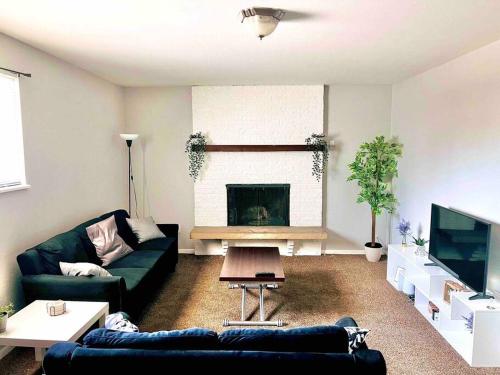 a living room with a couch and a fireplace at Modern Home Near Downtown in Denver
