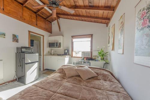 a bedroom with a large bed and a kitchen at Studio A mile from the best south Bay Beach in Redondo Beach