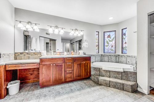 ein Badezimmer mit einer Badewanne und einem großen Spiegel in der Unterkunft Sonoran Oasis in Mesa